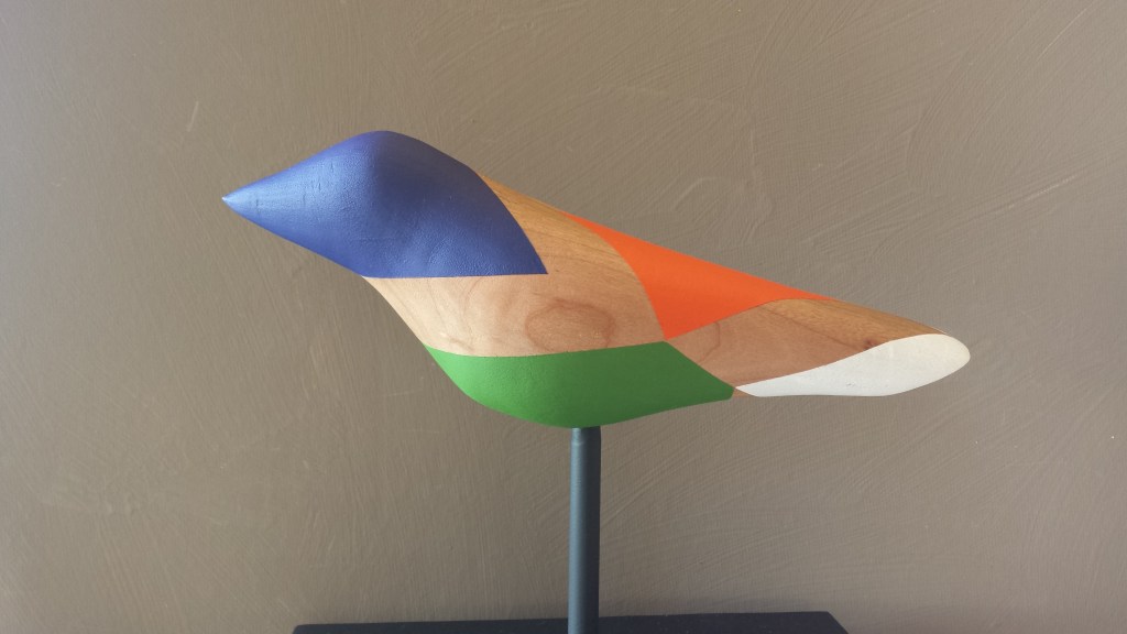 Multicolored, blue headed bird